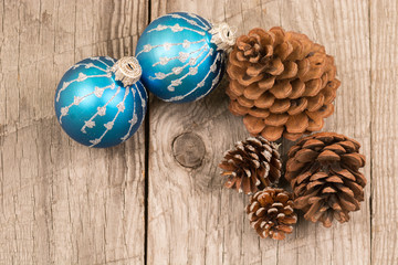 Christmas baubles and pine cones top view