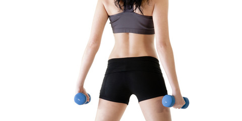 Fototapeta premium Close up of young woman exercising with dumbbells