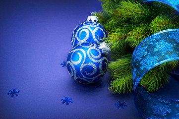 Christmas blue baubles with ribbon over blue background