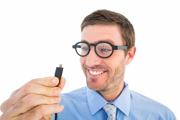 Geeky businessman holding a cable