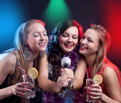 attractive young people dancing at disco and having fun and making selfie