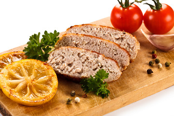 Fried chops and vegetables on cutting board