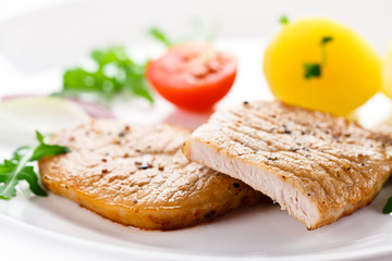 Fried steaks, boiled potatoes and vegetable salad