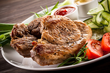 Barbecued steak, boiled potatoes and vegetable salad