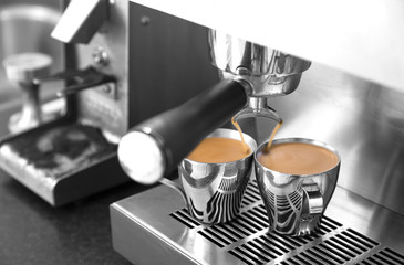 Making espresso on stainless steel espresso machine.