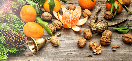 mandarine fruits and walnuts with christmas decorations