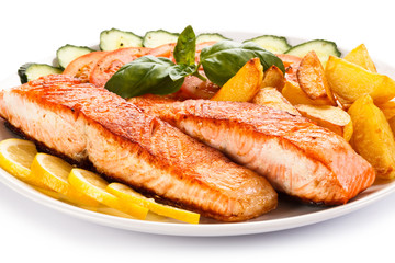 Grilled salmon and vegetables on white background