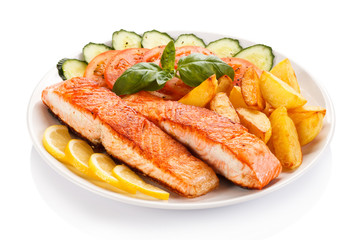 Grilled salmon and vegetables on white background
