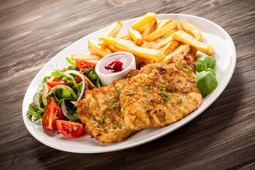 Pork chop, French fries and vegetables