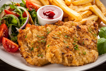 Pork chops, French fries and vegetables
