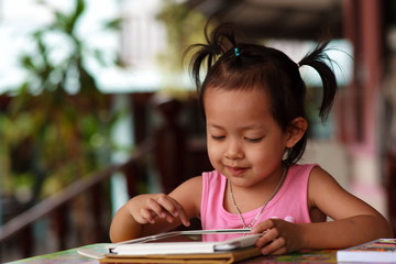 Happy child staring tablet.