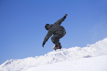 Naklejka na ściany i meble Extreme Snowboarder jumping
