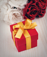 red flowers and gift box with yellow ribbon