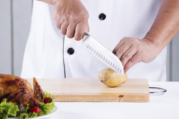 chef cutting potato