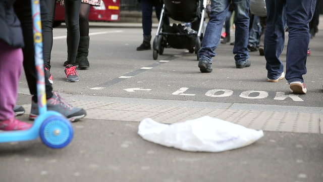Legs of people walking on London street crossing near parliament square