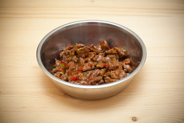 bowl with meat for the animal. Food for dogs and cats