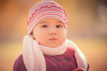 Beautiful outdoor autumn portrait of adorable toddler girl