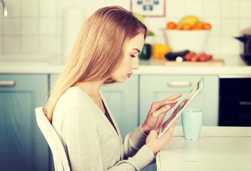 Beautiful caucasian woman working on tablet.