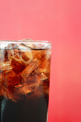 A glass of cola soft drink with ice cubes
