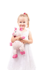 Cute little girl hold toy pig isolated