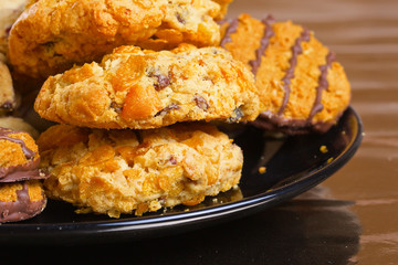 Variety of cookies on black plate