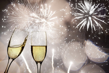 Glasses with champagne against fireworks