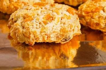 Tasty crunchy and crumbling cookies on yellow glossy paper