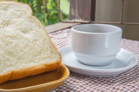 cup of coffee bread on table