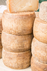 stacked rounded cheese for sale in market