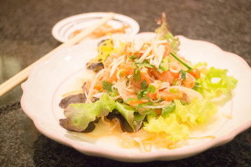 Spicy and sour salmon salad with vegetable and herb