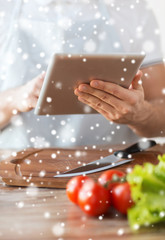 closeup of man reading recipe from tablet pc