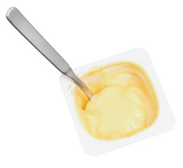 caramel yogurt and spoon in disposable cup