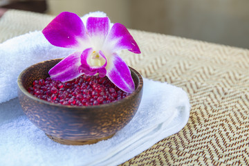 Spa and wellness setting with flowers and towel