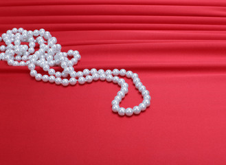 pearls beads on red silk