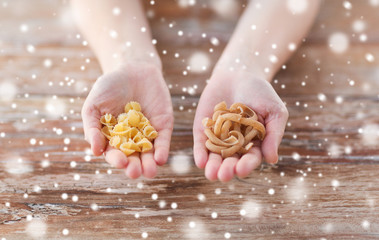 close up of hands with different pasta variations