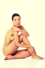 Fototapeta premium Sexy fit naked woman with healthy clean skin sitting