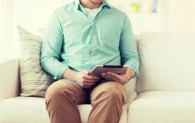 close up of man with tablet pc computer at home