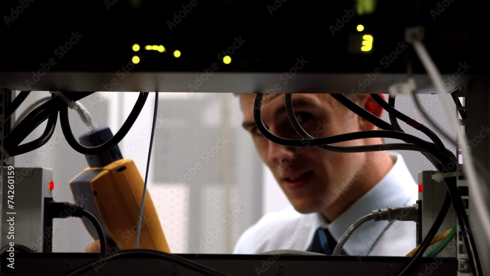 Aufkleber technician using digital cable analyzer on server