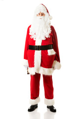 Full length Santa Claus holding a bell