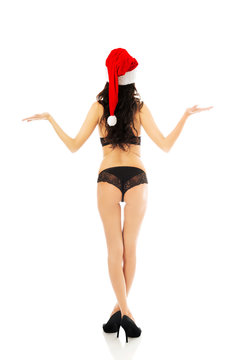 Back view woman with santa hat holding copyspace