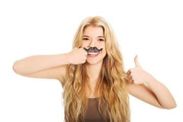 Blonde student with mustache looking at camera