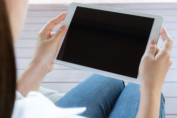 Woman hand hold white tablet with blank empty screen