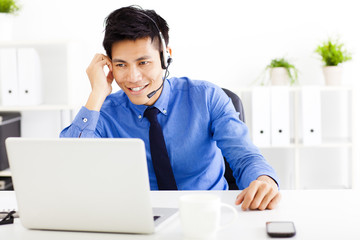 smiling businessman wearing a headset at the office