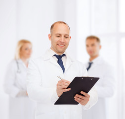 Plakat smiling male doctor with clipboard