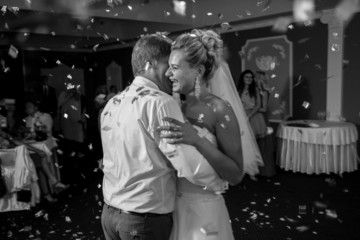 monochrome portrait of dancing at restaurant bride and groom