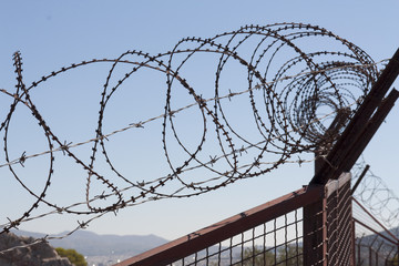 Security with a barbed wire fence. Protection concept design.