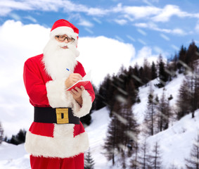 man in costume of santa claus with notepad