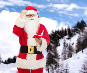 man in costume of santa claus with notepad