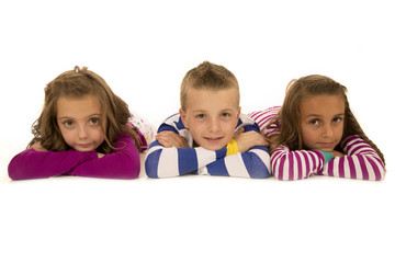 Children laying down in pajamas happy and smiling