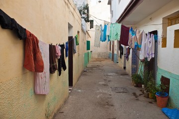 Narrow street with laundry in Asilah
